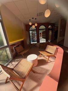 an overhead view of a room with chairs and a couch at ibis Sète Balaruc les Bains Bien-être et Spa in Balaruc-les-Bains