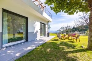 a house with a patio with a table and chairs at Relais Altacosta in Naples +55 photos