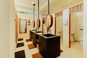 a bathroom with a sink and a mirror at Malkoha Studios in Dickwella