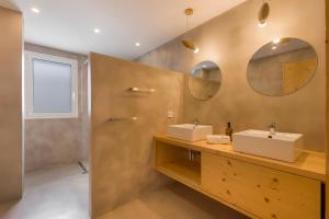 a bathroom with two sinks and two mirrors at Villa Linda in Punta Prima +32 photos