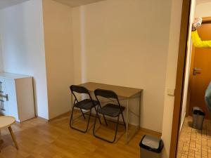 a small table and two chairs in a room at Spacious Rooms Near Center in Ljubljana +24 photos