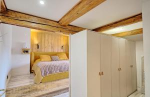 a bedroom with white cabinets and a bed at Meublés de tourisme Griotte et Cannelle in Bergbieten