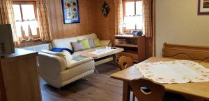 a living room with a couch and a table at Ferienhaus Breit in Eppenschlag