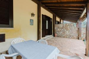 a table and chairs on the patio of a house at Baglio Montoleone in Castelluzzo