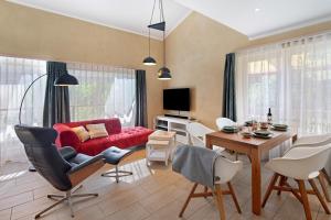 a living room with a red couch and a table at Leben am Weinberg in Herbstein