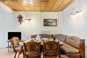 a dining room with a table and chairs and a couch at Ferienwohnung Schuhmacher in Donaueschingen