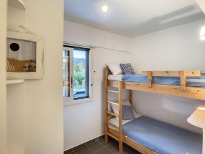 a bedroom with bunk beds in a tiny house at Beach Villa, Swimming pool for 8 in Thermisía +28 photos
