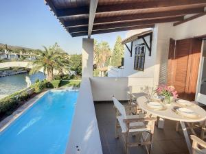 a patio with a table and chairs next to a pool at Beach Villa, Swimming pool for 8 in Thermisía