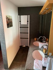 a bathroom with two pink sinks and a mirror at Fewo Matzing - beim Gartner in Matzing