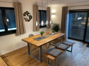 a dining room with a wooden table and chairs at Fewo Matzing - beim Gartner in Matzing +9 photos