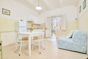 a kitchen and dining room with a table and a chair at Mare Etrusco 4 in Populonia