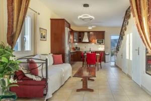 a living room with a couch and a table at Aegean Villas Ios in Ios Chora