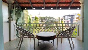a table and two chairs on a balcony at Plot 77 by hnh in Baga