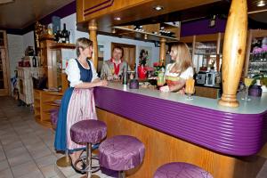 a couple of women standing at a bar at Simply Rooms in Velden am Wörthersee