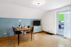 a dining room with a table and chairs and a television at Fewo Walk in Salem