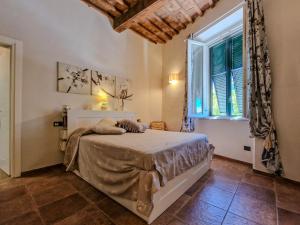 a bedroom with a bed and a large window at Casa Caterina in Portoferraio