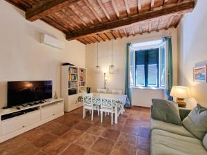 a living room with a couch and a dining room at Casa Caterina in Portoferraio