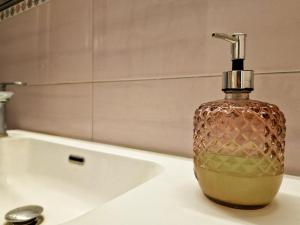 a soap dispenser sitting on a sink in a bathroom at Casa Caterina in Portoferraio +35 photos