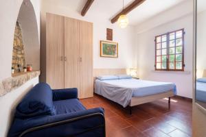 a bedroom with a bed and a couch at Torre Cappavecchia in Molfetta +27 photos