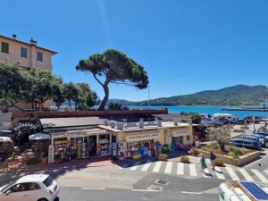 a parking lot with a store and a tree at Casa Caterina in Portoferraio