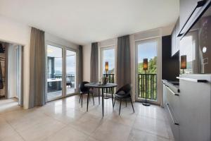 a kitchen with a table and chairs and windows at Egge Resort 7e mit Whirpool u Sauna in Altenbeken