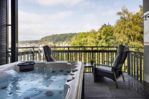 a hot tub on a balcony with a view at Egge Resort 7e mit Whirpool u Sauna in Altenbeken