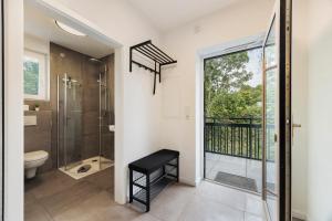 a bathroom with a shower and a toilet and a window at Egge Resort 7e mit Whirpool u Sauna in Altenbeken +16 photos