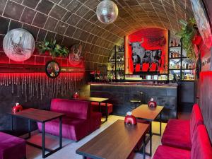 a restaurant with red chairs and tables and a bar at Araks Hotel Complex in Gyumri