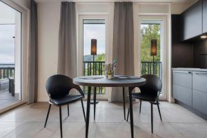 a kitchen with a table and chairs and a balcony at Egge Resort 7e mit Whirpool u Sauna in Altenbeken