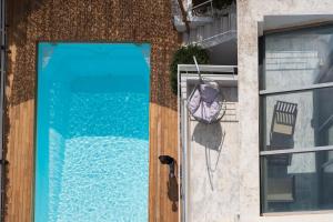 a door to a building with a swimming pool at Evaeri villa in Artemida