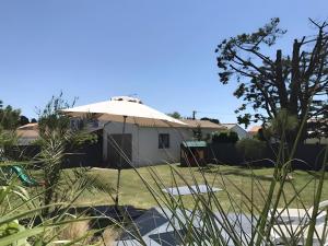 a house with an umbrella in a yard at Le Nid Marin - 76 in Pornic +3 photos