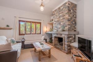 a living room with a fireplace and a couch at S'escodra in Llucmajor