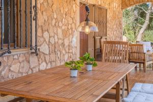 a wooden table with two potted plants on it at S'escodra in Llucmajor