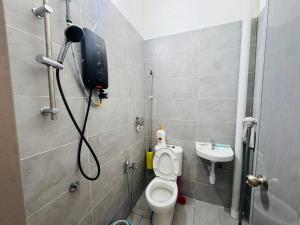 a bathroom with a shower with a toilet and a sink at Pitstop Homestay Klia in Banting