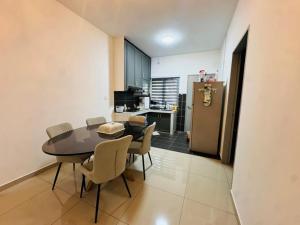 a kitchen and dining room with a table and chairs at Pitstop Homestay Klia in Banting