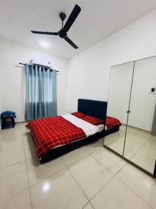 a bed in a room with a ceiling fan at Pitstop Homestay Klia in Banting