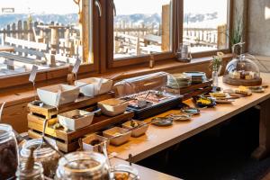 a buffet of food on a table with a view at Rossalm in Brixen