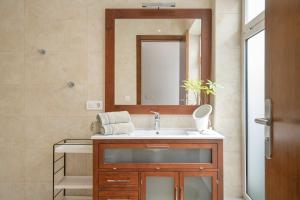 a bathroom with a sink and a mirror at Garden Apartment in Tías +10 photos