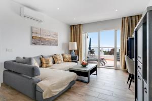 a living room with a couch and a tv at Garden Apartment in Tías