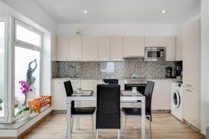 a kitchen with a table and chairs in a room at Garden Apartment in Tías