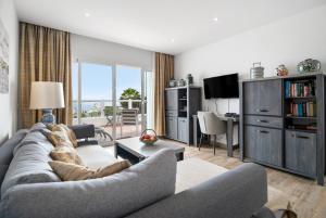 a living room with a couch and a table at Garden Apartment in Tías