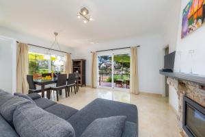 a living room with a couch and a fireplace at Na Pallissera in Santanyi