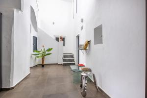 a hallway with a glass table and white walls at Casa Privada in Vejer de la Frontera