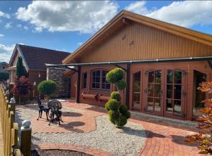 a home with a patio and a house at Idylle Ferienhaus Ems in Walchum
