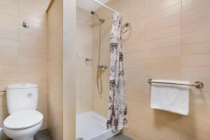 a bathroom with a toilet and a shower at Puerto Playa 2 in Puerto del Rosario +15 photos