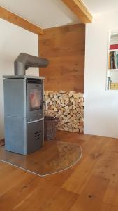 a wood stove in a room with a stone wall at Den Bergen Ganz Nah in Pfronten