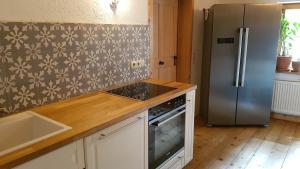 a kitchen with a refrigerator and a sink at Den Bergen Ganz Nah in Pfronten +11 photos