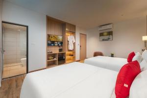 a hotel room with two beds and a bathroom at Lam Anh Hotel 10 Ngoai Giao Doan in Hanoi