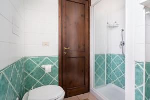 a bathroom with a toilet and a shower at Appartamento da Manzela 2 in Cala Gonone +11 photos