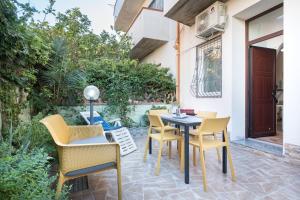 a patio with chairs and a table on a patio at Appartamento da Manzela 2 in Cala Gonone